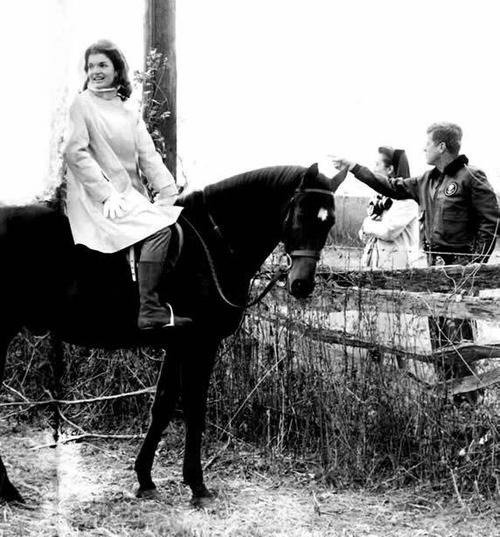 Jackie Kennedy taking a break from riding to chat with her husband John F. Kennedy, and her sister Lee Radziwill.